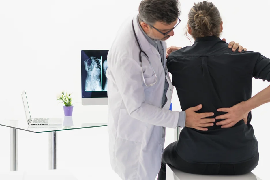 doctor checks the patient's back pain issues caused by constipation