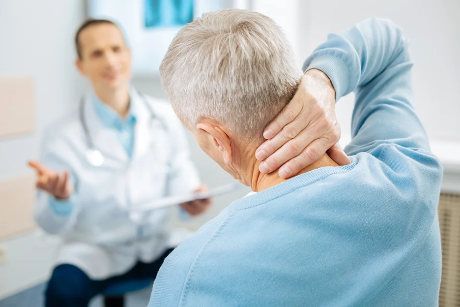 a senior man complains neck pain to his doctor