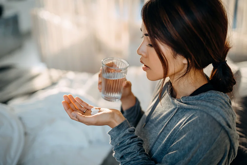 a woman taking medication for pneumonia 